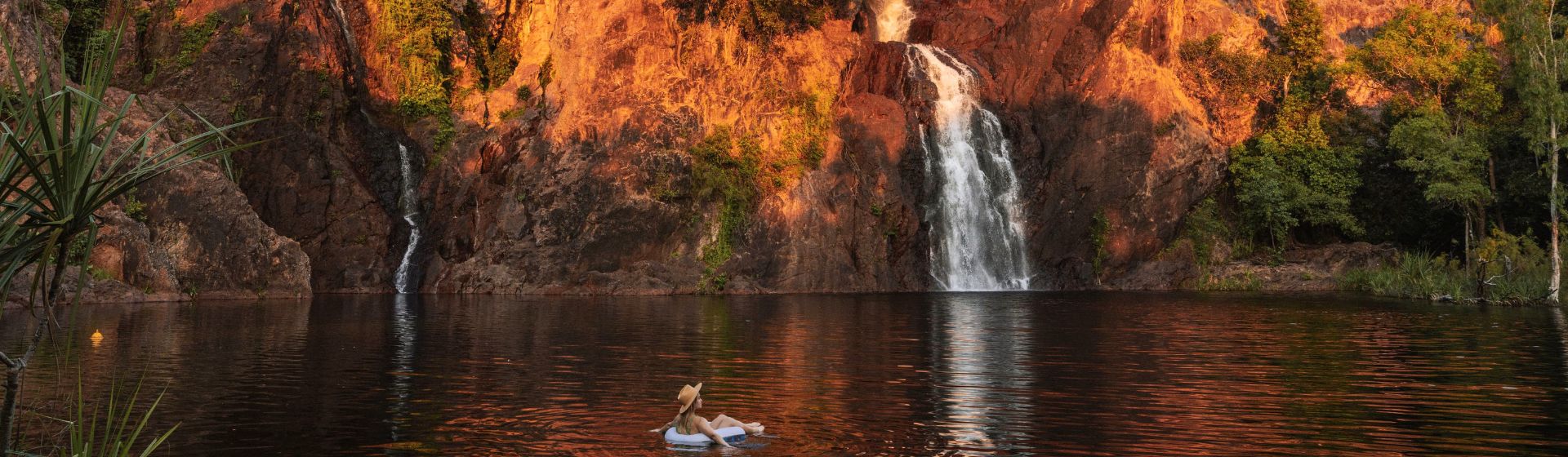 A lady sitting on an inflatable float at Wangi Falls, Litchfield National Park, Australia