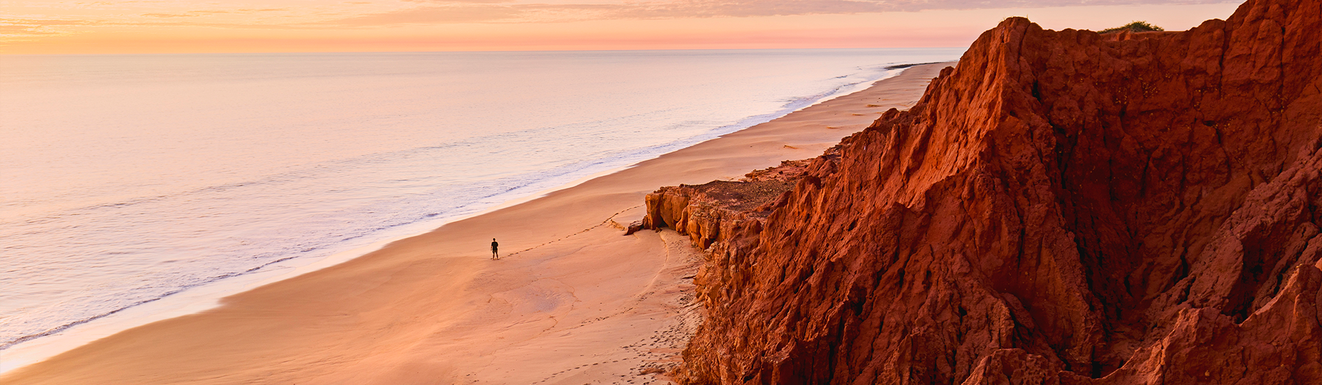 A person walking along the shores of James Price Point in Broome, Western Australia